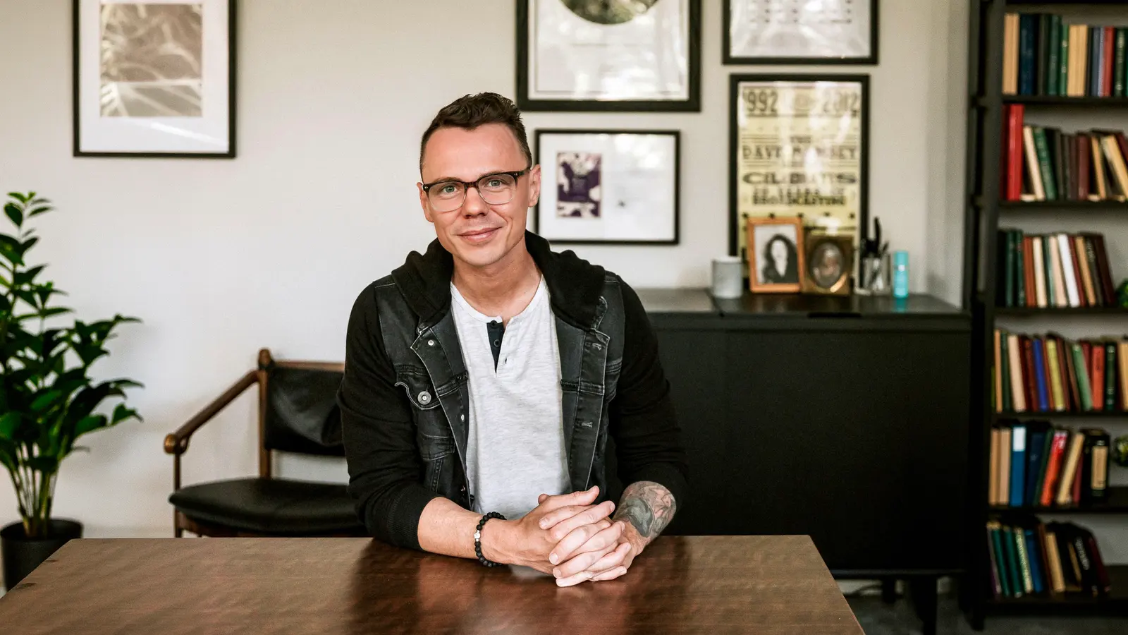 Robbie Poe seated at a table in his office