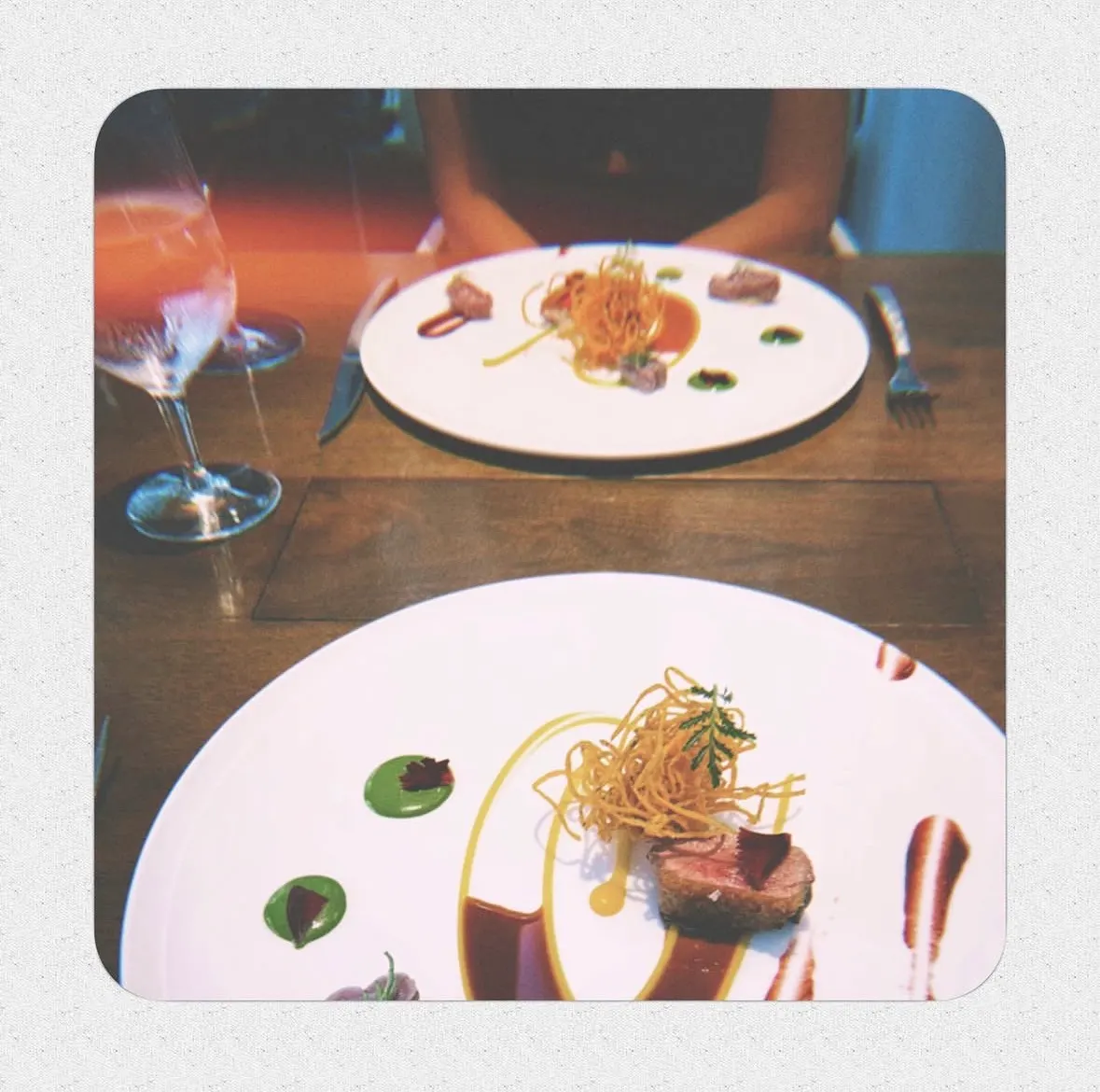 Two artfully plated dishes at a restaurant table