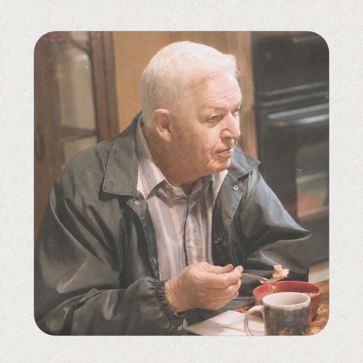 An older man seated at a dining table